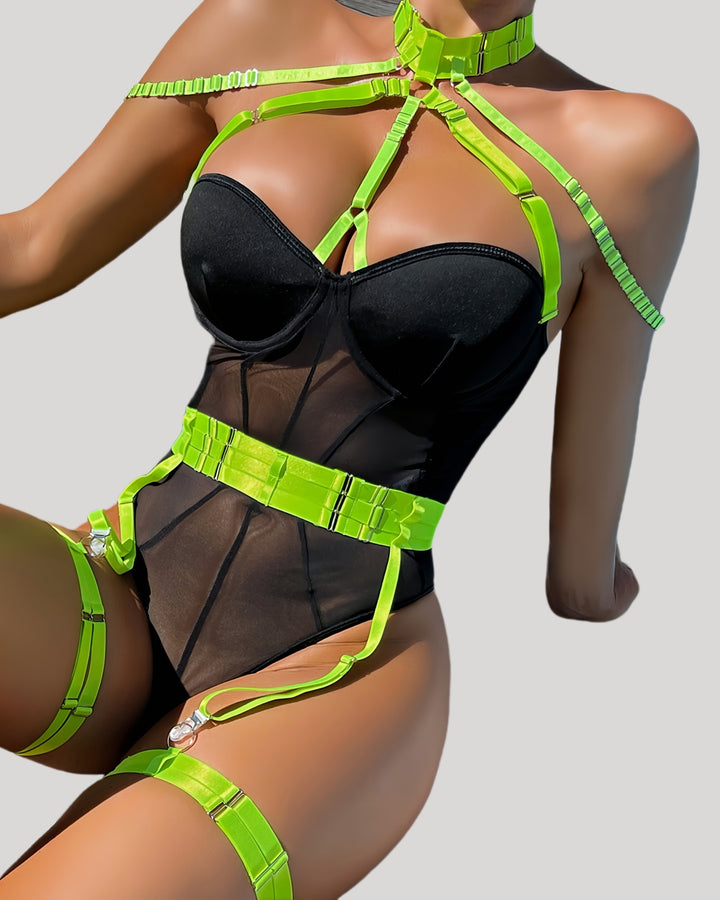 Front view of a sheer black teddy with neon green harness straps