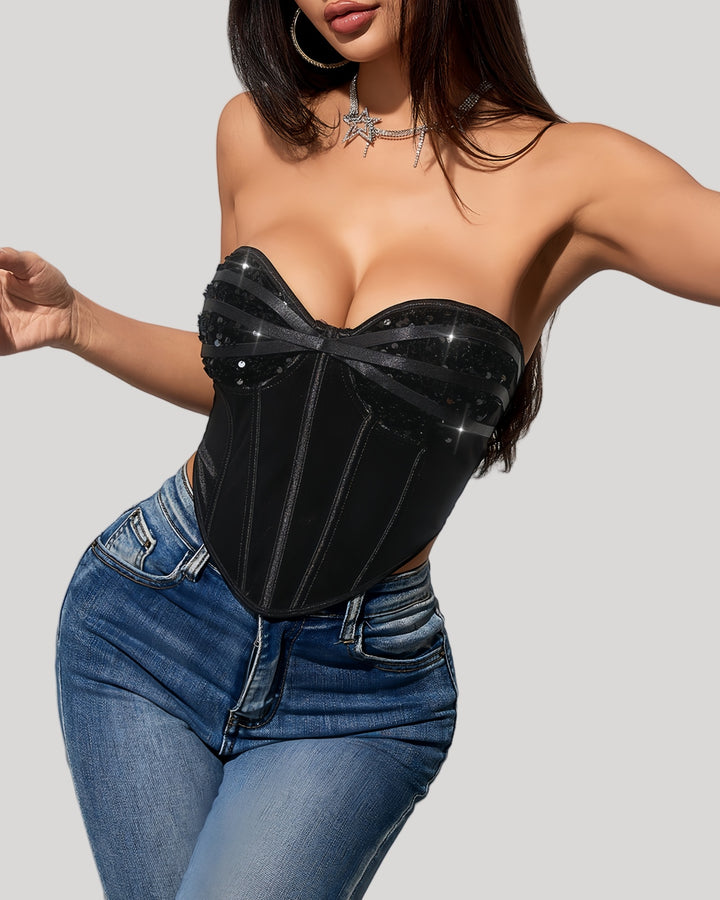 Model in black strapless sequin corset top with jeans