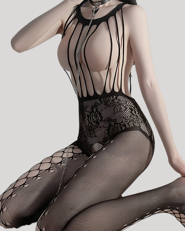 Model kneeling in black strappy lace bodystocking