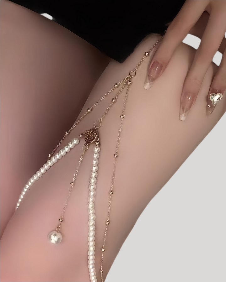 Gold pearl leg chain accessory draped along thigh with luxurious detailing