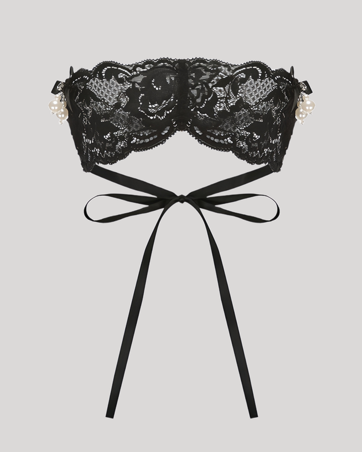 Flat lay of black lace blindfold with satin ribbons