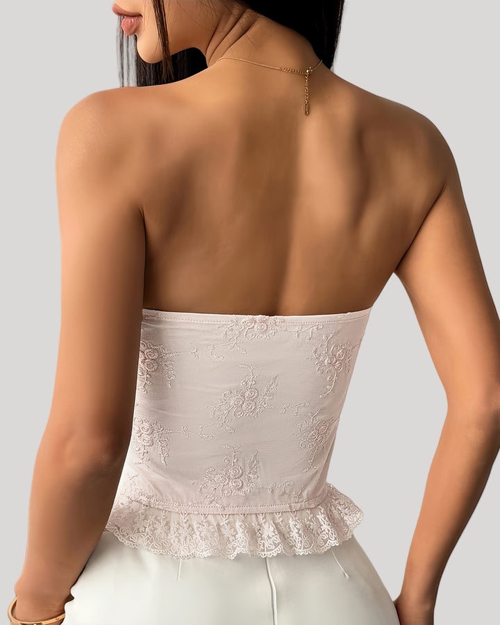 Woman wearing pink floral embroidered corset with lace-up front and 3D flower bustline