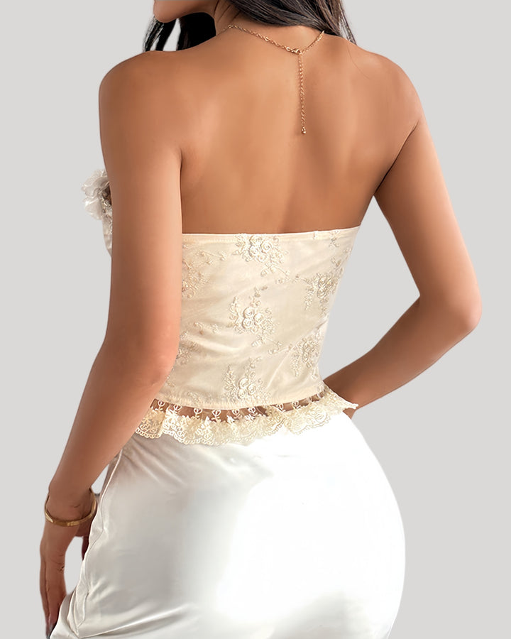 Woman wearing white floral embroidered corset with lace-up front and 3D flower bustline
