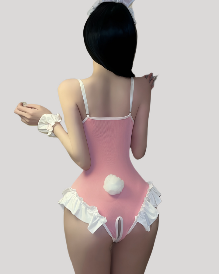 Model wearing a pink lace-trimmed bunny bodysuit with matching ears and wrist cuffs
