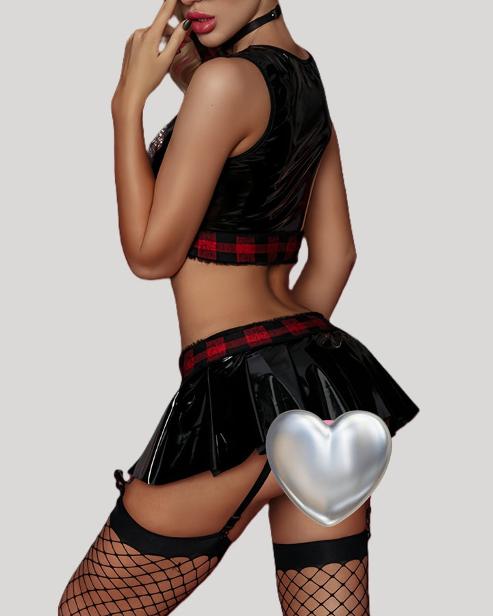Side view of model in vinyl schoolgirl outfit looking over shoulder