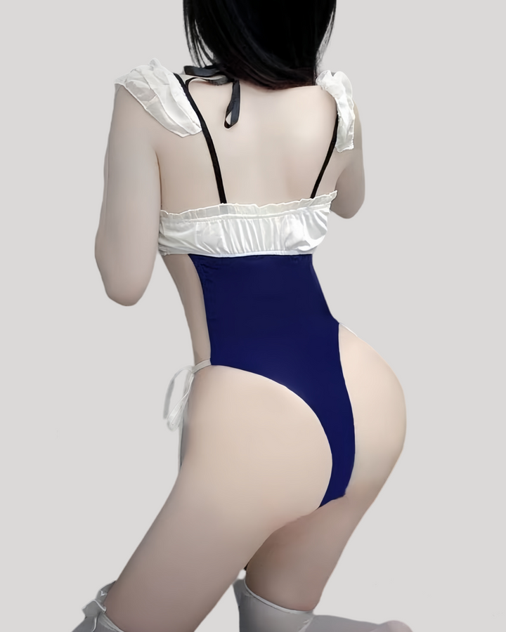 Person wearing a blue lace top and blue bodysuit on a plain background
