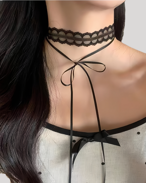Model wearing black lace choker with long satin ribbon tied at neck