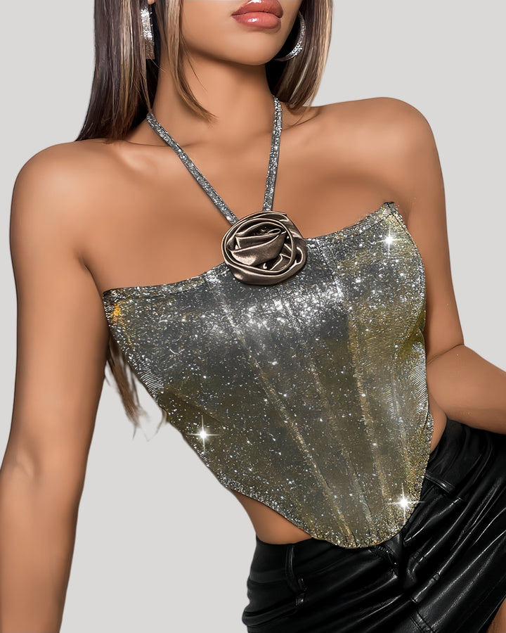 Model wearing silver-to-gold ombré bustier with halter neck and rose appliqué