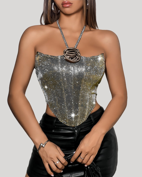 Model wearing silver-to-gold ombré bustier with halter neck and rose appliqué