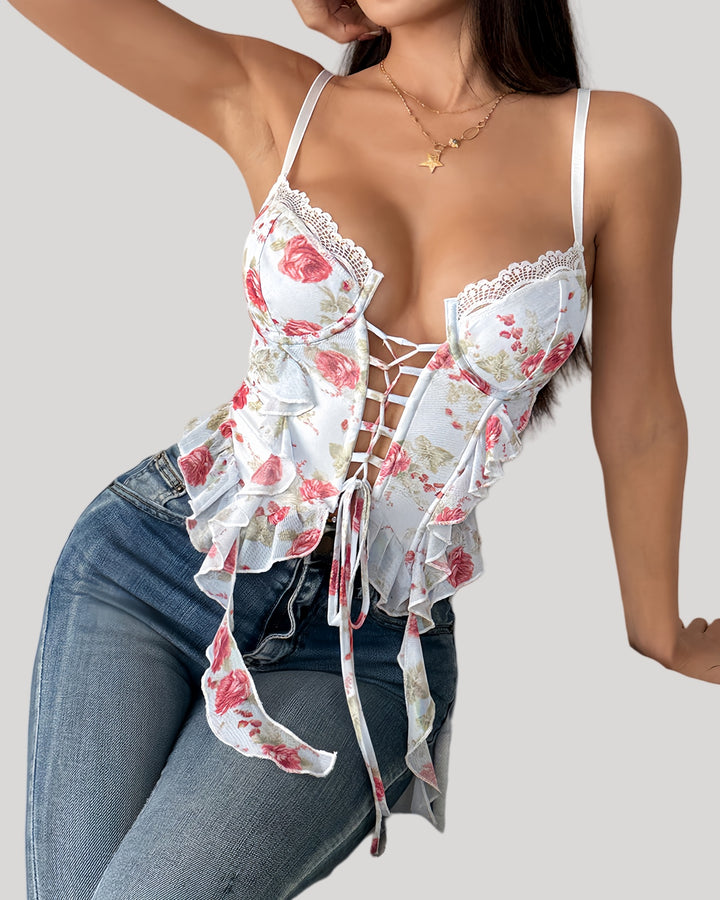 Model wearing floral bustier paired with jeans, showing lace-up detail