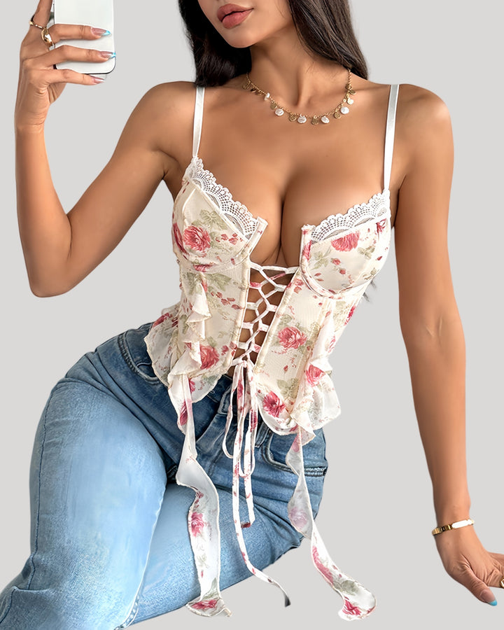 Model wearing floral bustier paired with jeans, showing lace-up detail