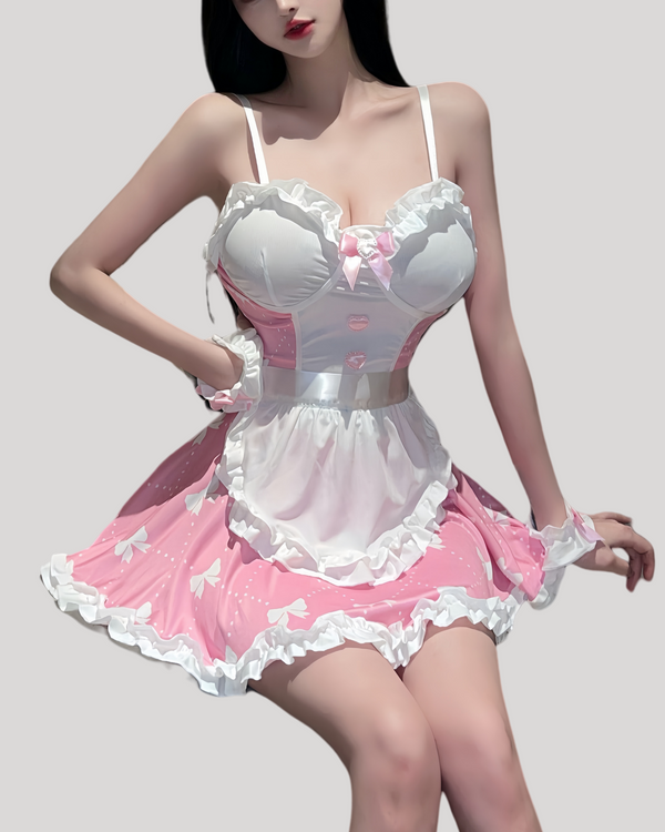 Front view of pink maid dress with satin bow, pearl charm, and removable white apron