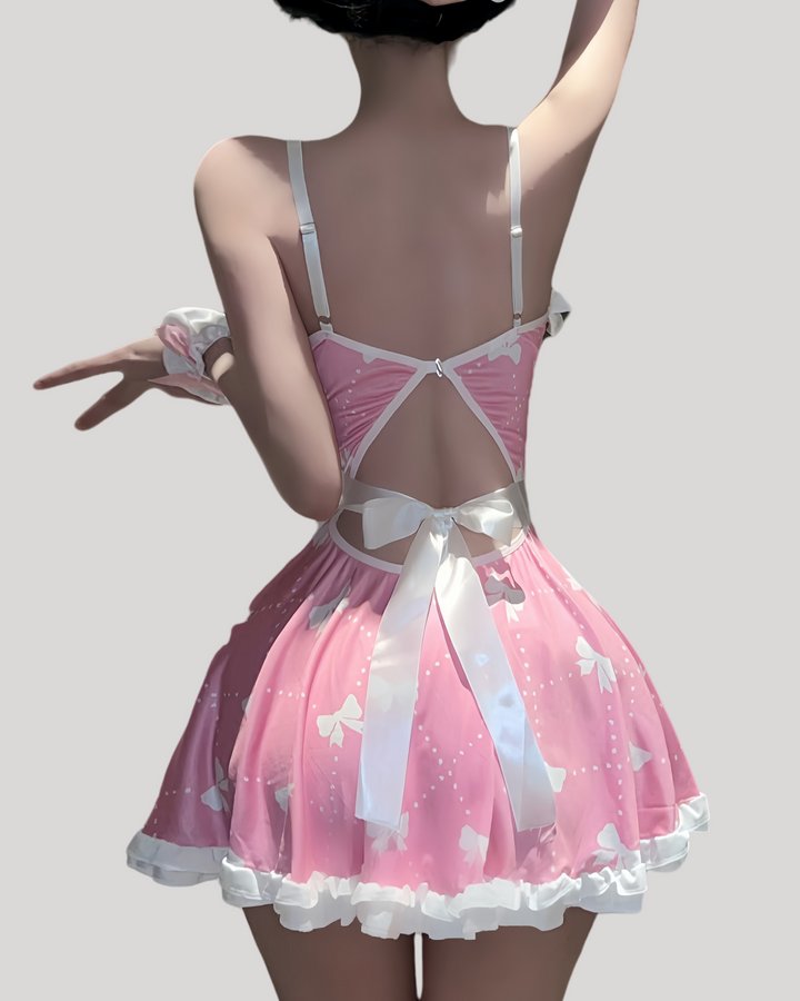 Back view of pink maid dress with satin bow, pearl charm, and removable white apron