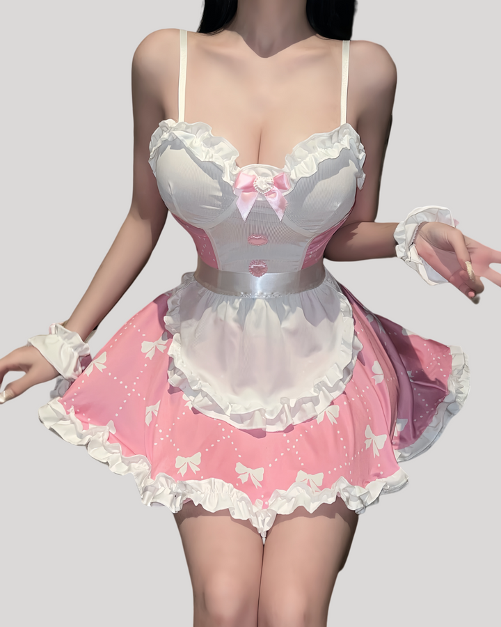 Front view of pink maid dress with satin bow, pearl charm, and removable white apron