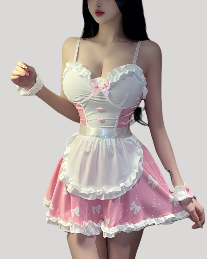 Front view of pink maid dress with satin bow, pearl charm, and removable white apron
