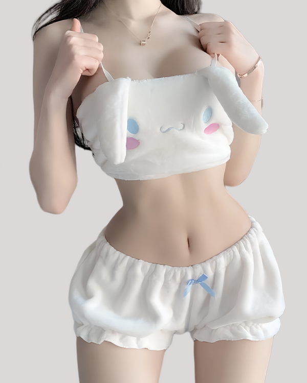 Woman wearing white plush bandeau cami with floppy Cinnamoroll ears and embroidered face, paired with ruffled elastic-waist shorts featuring a small blue bow