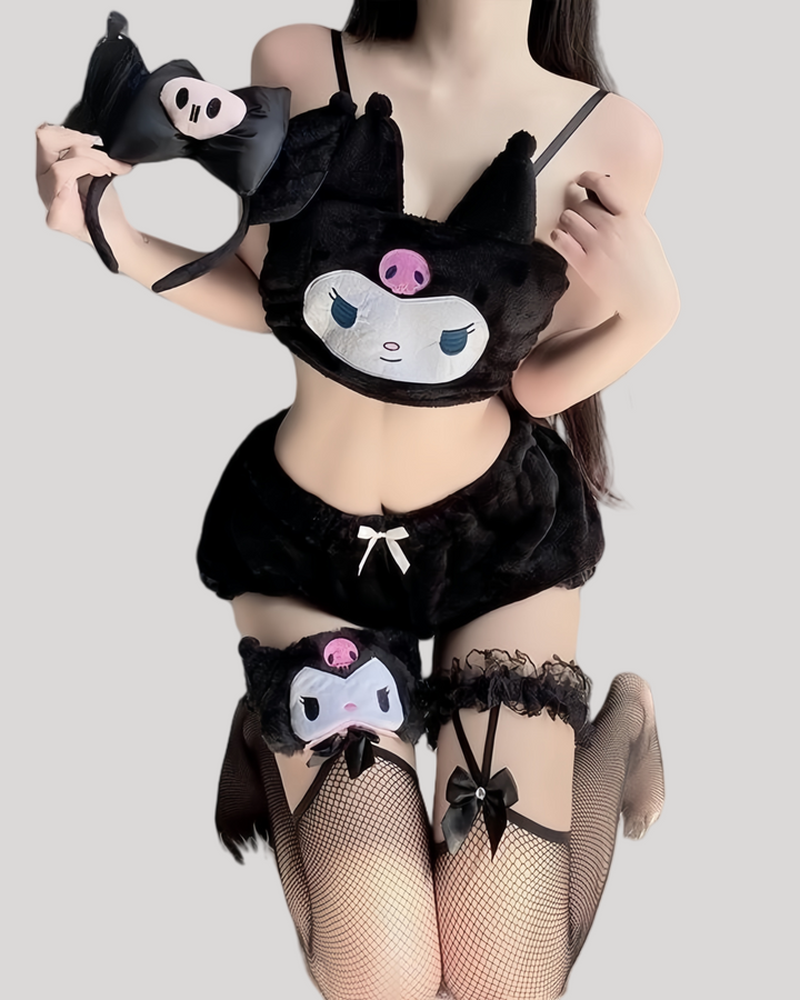 Person wearing black Kuromi plush bandeau top with skull-decorated ears and embroidered face, matched with black fuzzy ruffle shorts and a small satin bow