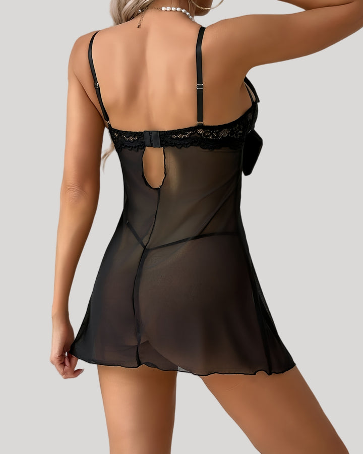 Model in black sheer babydoll featuring large satin bow