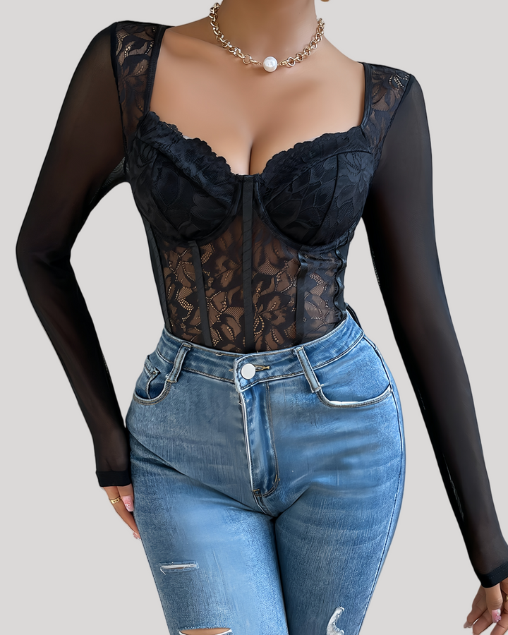 Front view of black sheer lace underwire corset bodysuit with mesh long sleeves on model