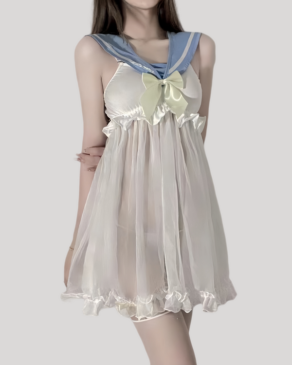 Model wearing sheer ivory babydoll dress with powder-blue sailor collar and satin bow
