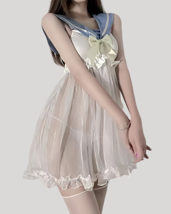 Model wearing sheer ivory babydoll dress with powder-blue sailor collar and satin bow
