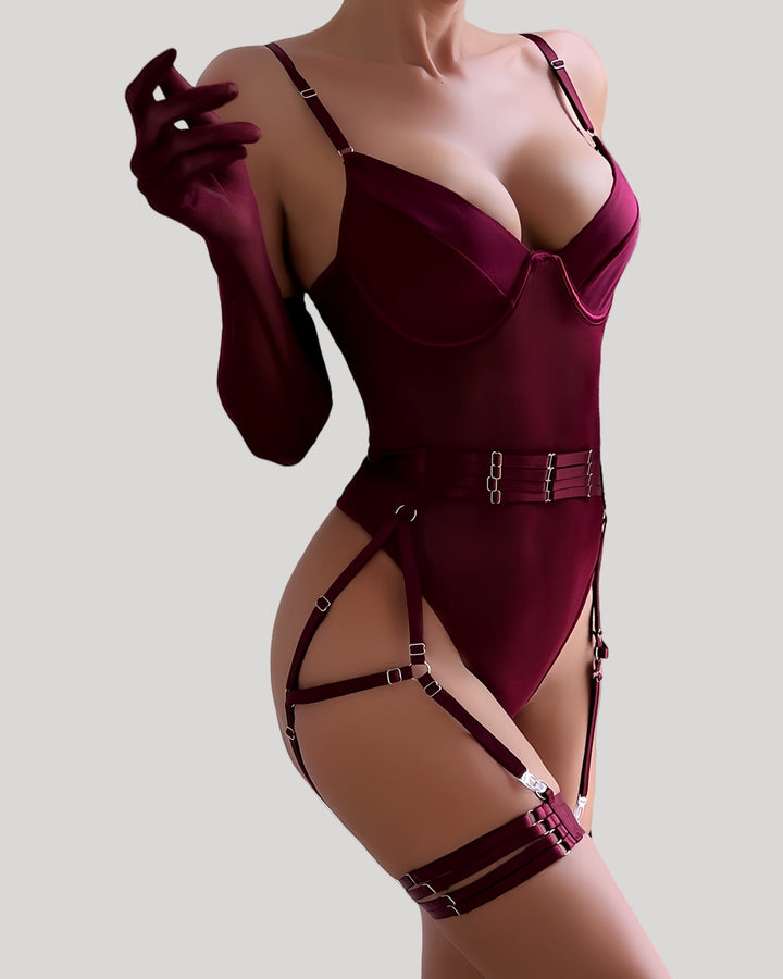 Front view of model wearing red mesh and velvet strap bodysuit with matching gloves