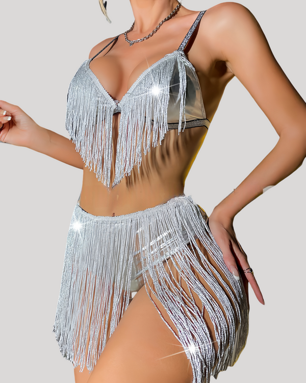 Front view of model in a silver foil triangle bralette adorned with cascading fringe over a sheer midriff panel.