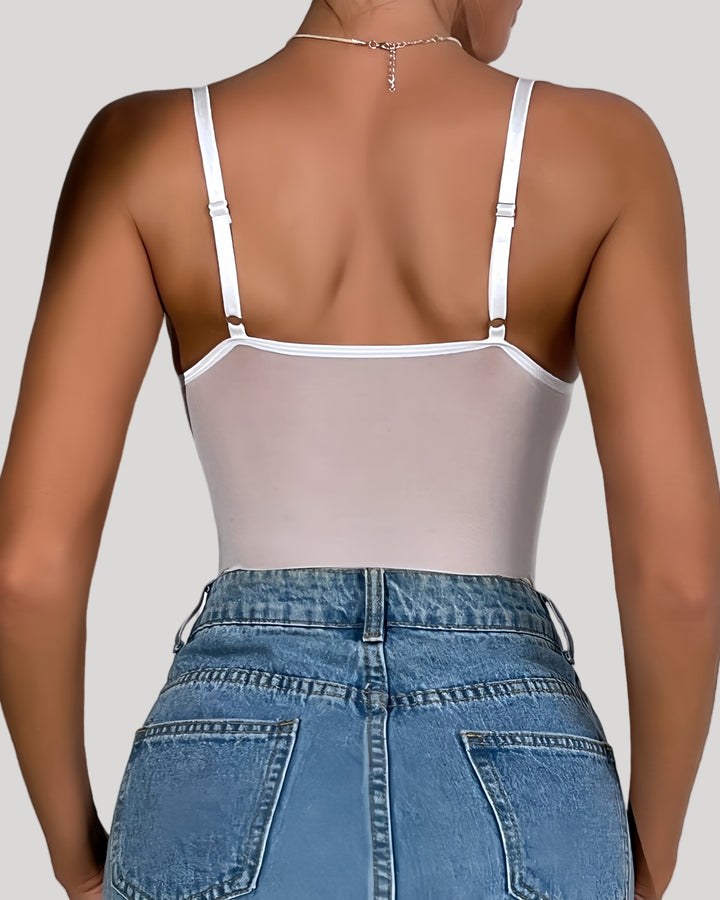 Back view of mesh-panel white bodysuit paired with jeans