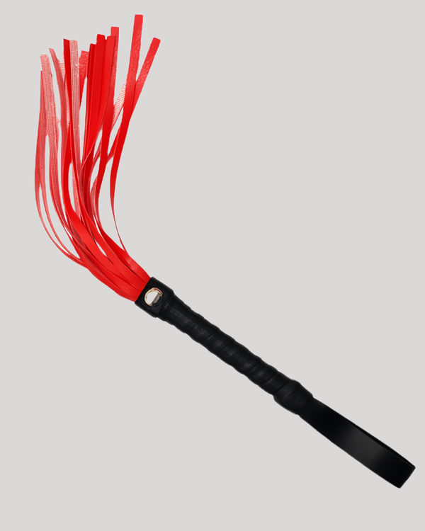 Red and black leather tassel whips standing on display