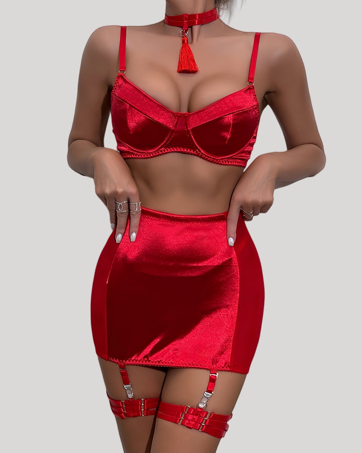 Model wearing red satin bra and mini skirt set with tassel choker