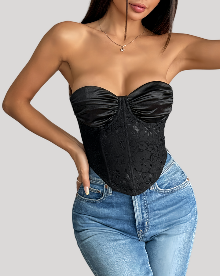 Model wearing black strapless satin and lace bustier with jeans