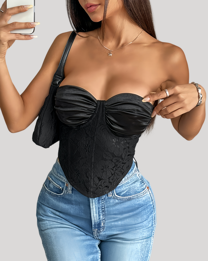 Model wearing black strapless satin and lace bustier with jeans