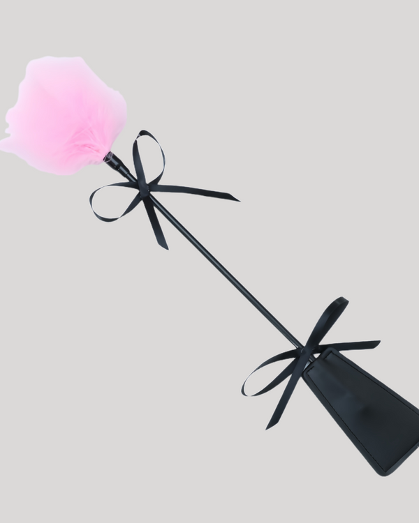 Pink feather and leather paddle for sensual play